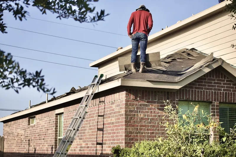 Professional roofer working on a residential roof in Dawsonville